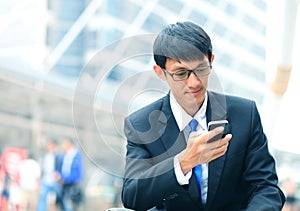 Man on smart phone - young business man. Casual urban profession