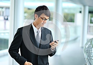Man on smart phone - young business man. Casual urban profession