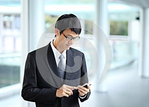 Man on smart phone - young business man. Casual urban profession