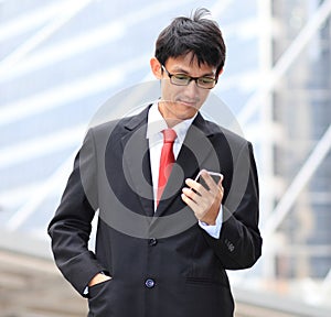 Man on smart phone - young business man. Casual urban profession