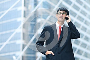 Man on smart phone - young business man. Casual urban profession