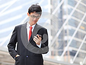 Man on smart phone - young business man. Casual urban profession