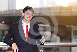 Man on smart phone - young business man. Casual urban profession