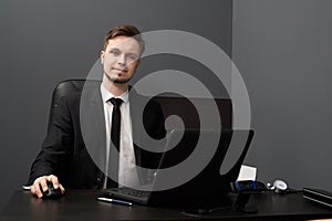 Man in smart suit posing while working with lie detector