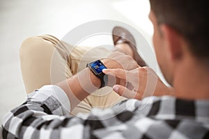 Man with smart watch indoors, closeup view