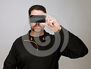 Man with smartphone by face
