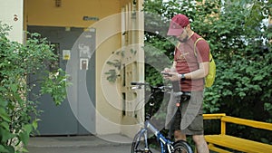 Man with smartphone and folding bicycle