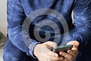 A man with a smartphone in his hands. Close-up shot.