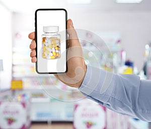 Man with smartphone ordering medications online