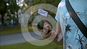 Man with smartphone receiving a letter