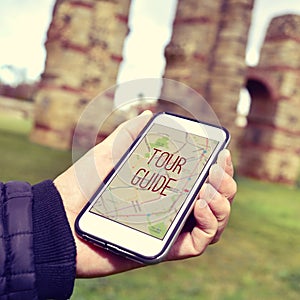 Man with a smartphone with the text tour guide