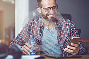 Man with smartphone and water