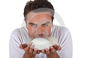 Man smelling bars of soap