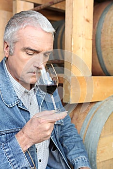 Man smelling red wine