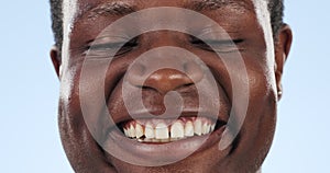 Man, smile and happy in studio closeup by blue background, confident and positive mindset. African person laughing