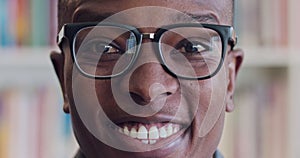 Man, smile and macro portrait of face with glasses, in library or bookstore, with author or librarian. Black man, happy