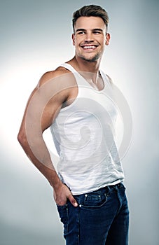 Man, smile and strong on white background or funny with humour while in a vest, fashion and care for wellness. Male photo