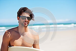 Man smile, surf and vacation with sunglasses by the beach and sea for fitness and water sport with mockup space