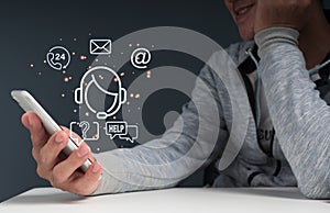 A man smiles while holding a versual screen with an operator\'s emblem and icons for after-sales services.