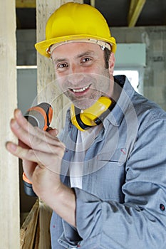 man smiling with drill isolated on white background