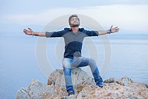 Man smiling looking up to blue sky celebrating freedom