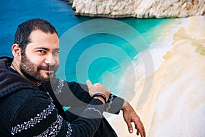 Man smiling near the coast of KaputaÅŸ. Amazing beach and coastline from Kaputas, Antalya, Turkey. The  Holiday concept