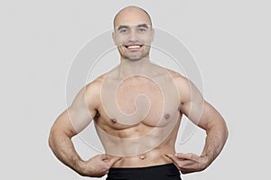 Man smiling showing abs.