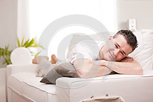 Man smiling to camera relaxing in his living room