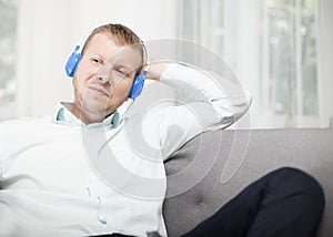 Man smiling to himself as he listens to music