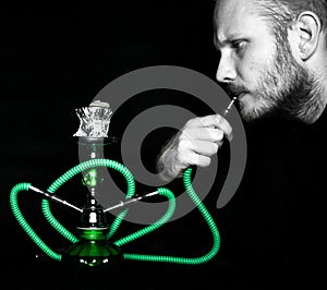 Man smokes a hookah