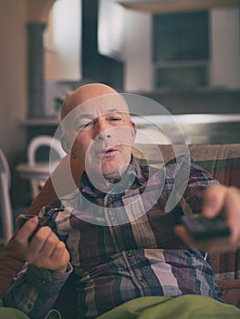 Man with smoking pipe watching tv