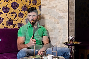 Man Smoking Shisha In The Arabic Cafe