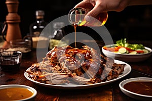 man smothering pulled pork with carolina vinegar sauce