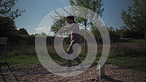 Man in sneakers learns walk and balance on balancing rope from rubber in a park in Germany. Sport, leisure, recreation