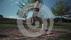 Man in sneakers learns walk and balance on balancing rope from rubber in a park in Germany. Sport, leisure, recreation