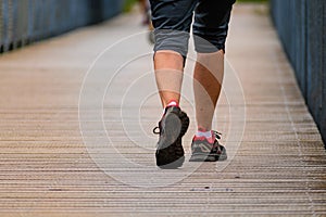 Man with sneakers running on a path, helathy activity to make exercice