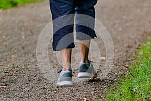 Man with sneakers running on a path, helathy activity to make exercice