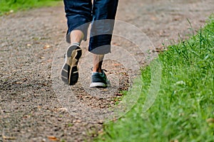 Man with sneakers running on a path, helathy activity to make exercice