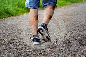 Man with sneakers running on a path, helathy activity to make exercice