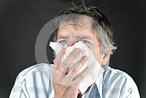 Man Sneezes Into Tissue Front