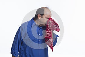 Man sneezing into his handkerchief, horizontal