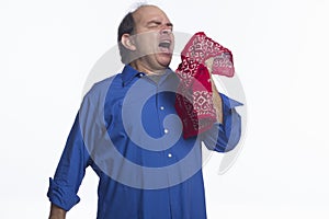 Man sneezing into his handkerchief, horizontal