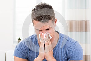 Man Sneezing In Tissue Paper