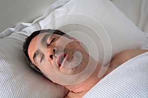 Man snoring in bed