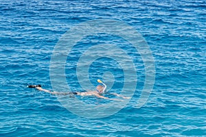 man with snorkel mask tuba and snorkel in sea. Snorkeling, swimming, vacation. Tourists are engaged in snorkeling in the open sea