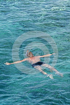 man with snorkel mask tuba and snorkel in sea. Snorkeling, swimming, vacation. Tourists are engaged in snorkeling in the open sea