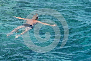 man with snorkel mask tuba and snorkel in sea. Snorkeling, swimming, vacation. Tourists are engaged in snorkeling in the open sea