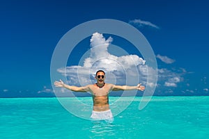 Man snorkeling in clear tropical waters in front of exotic island