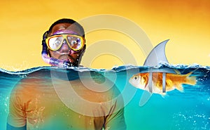 Man with snorkeling mask is scared to go underwater. yellow background