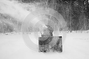 Man Snow Blowing Driveway